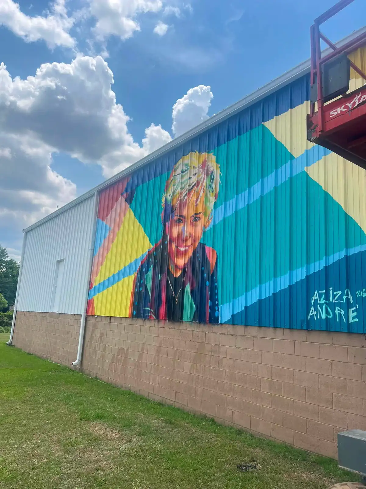 Completed commercial exterior portrait mural Colorful completed portrait mural painted on a commercial building exterior