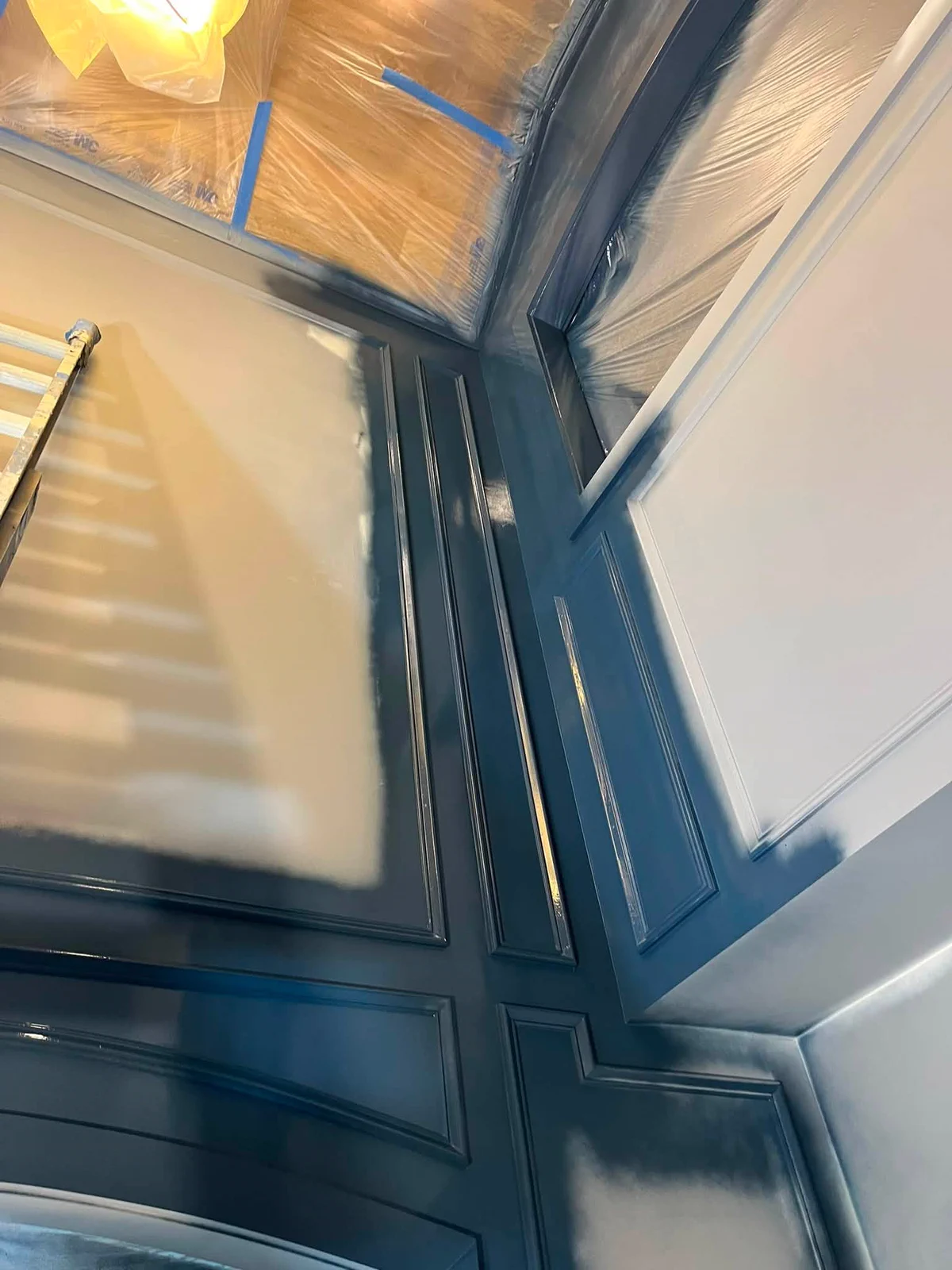 Paneled foyer wall during the multi-step decorative finishing process