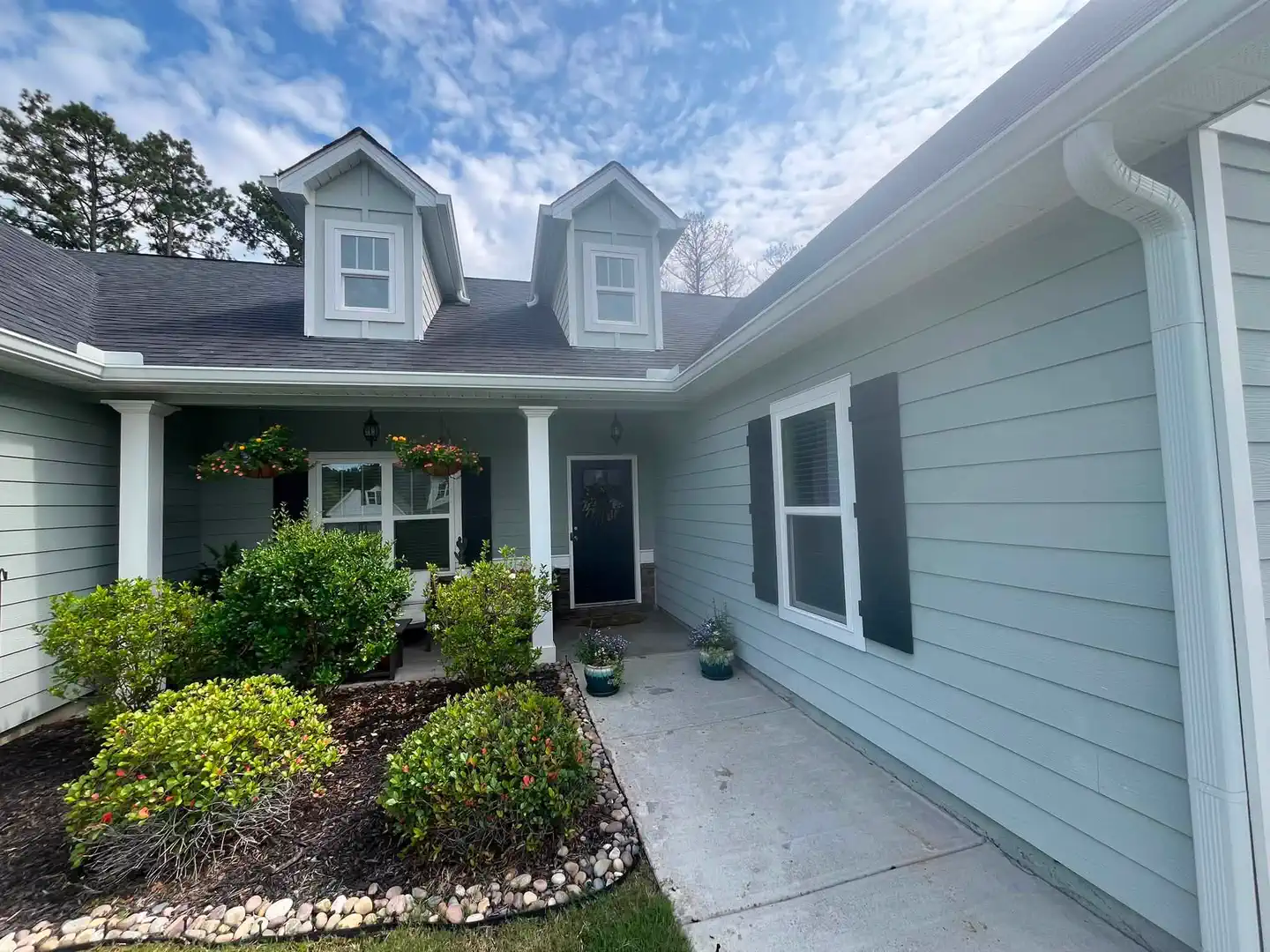 Fresh blue-gray exterior finish around the covered front entry