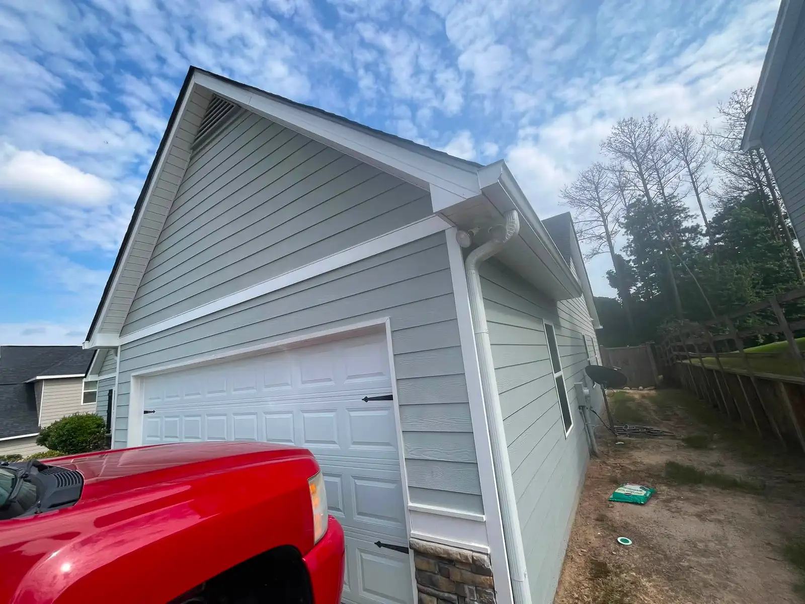 Blue-gray exterior paint completed around the garage wing