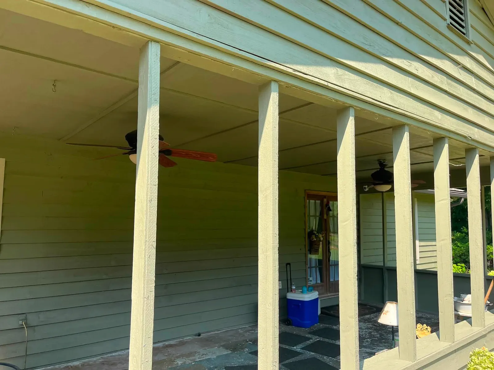 Porch columns and siding prepared during the green home exterior project