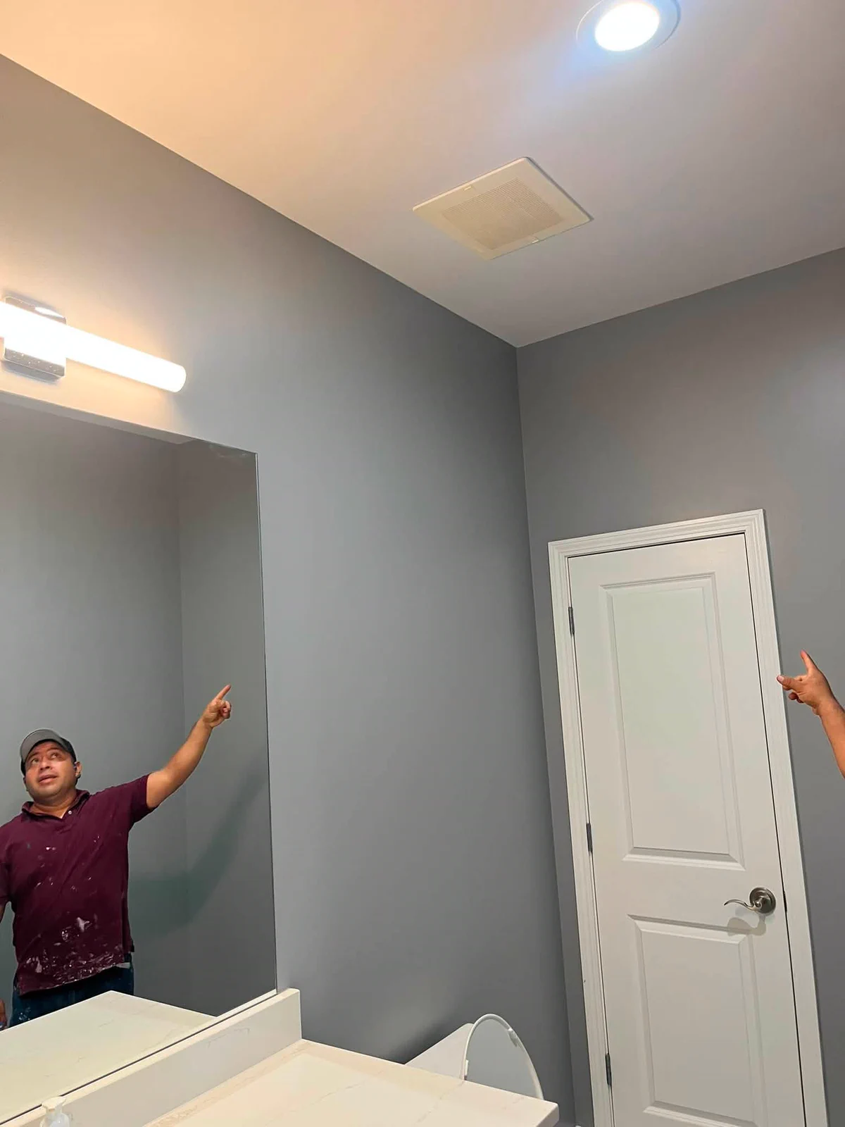 Finished gray bathroom walls with clean white trim and ceiling lines