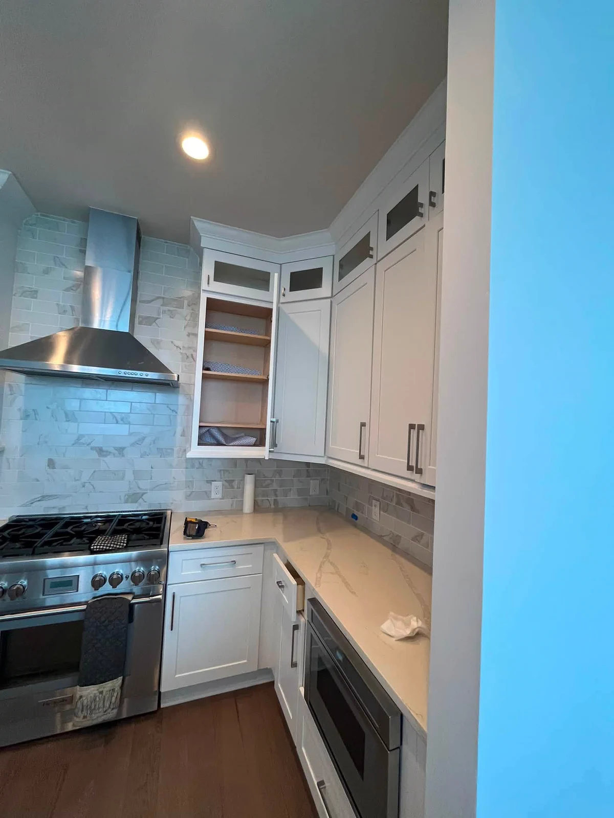 Freshly finished white cabinetry and clean wall paint in the high-rise kitchen