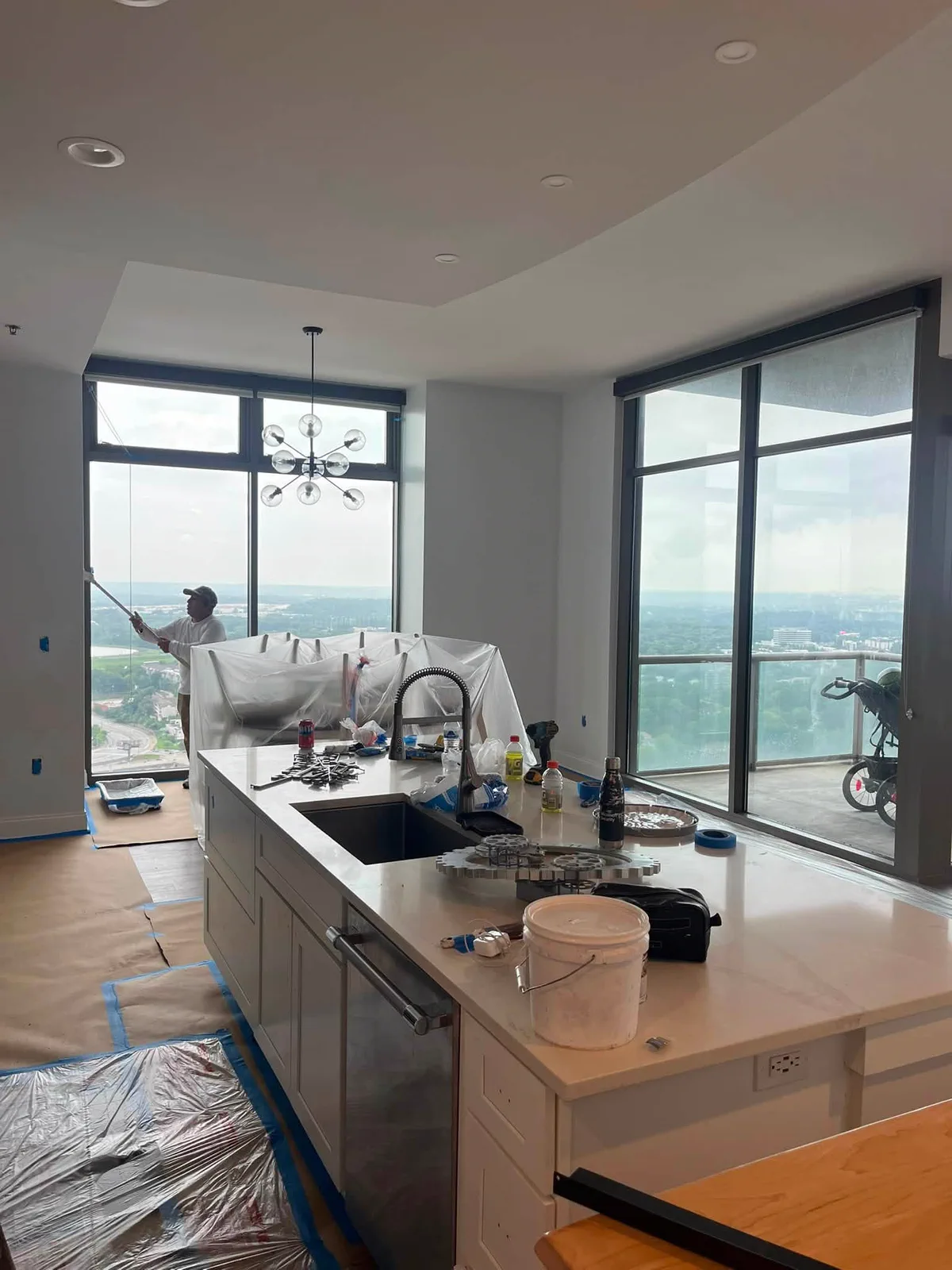 Kitchen island and surrounding surfaces protected during repainting