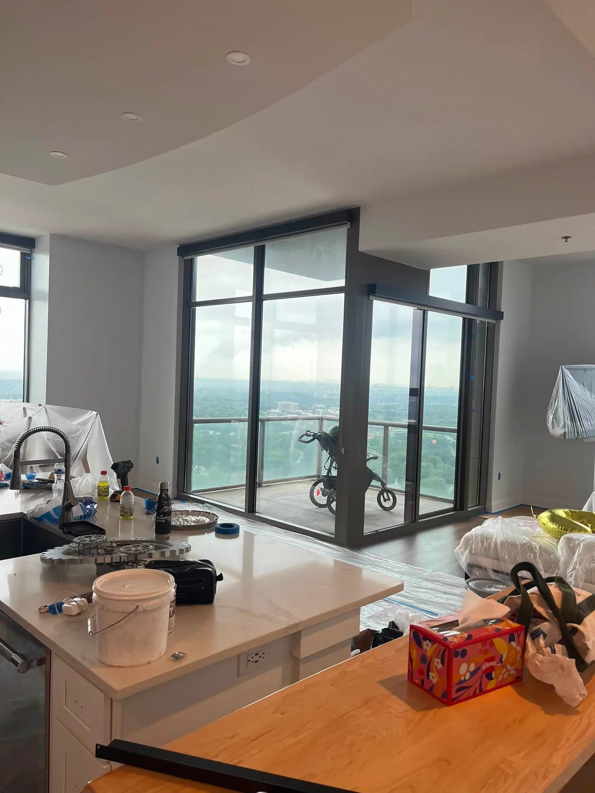 High-rise kitchen protected and prepared during interior painting