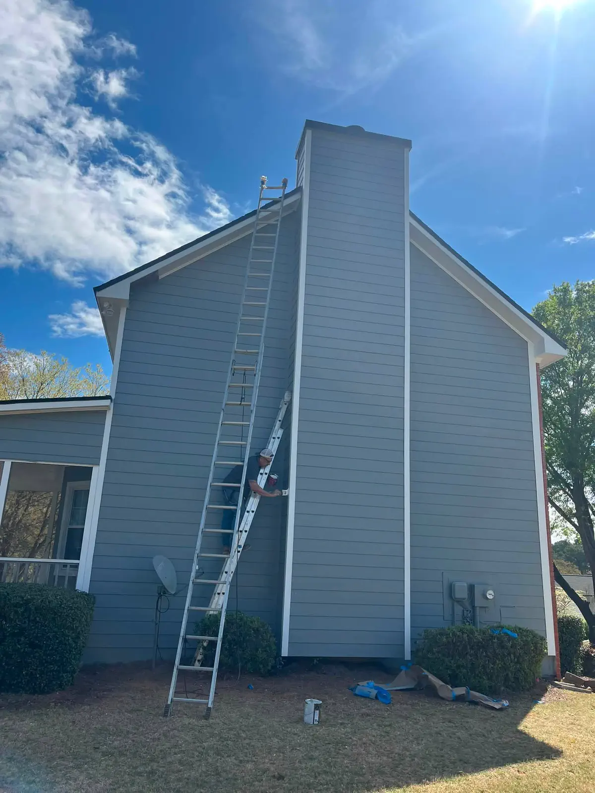 Blue-gray finish applied around the chimney-side exterior