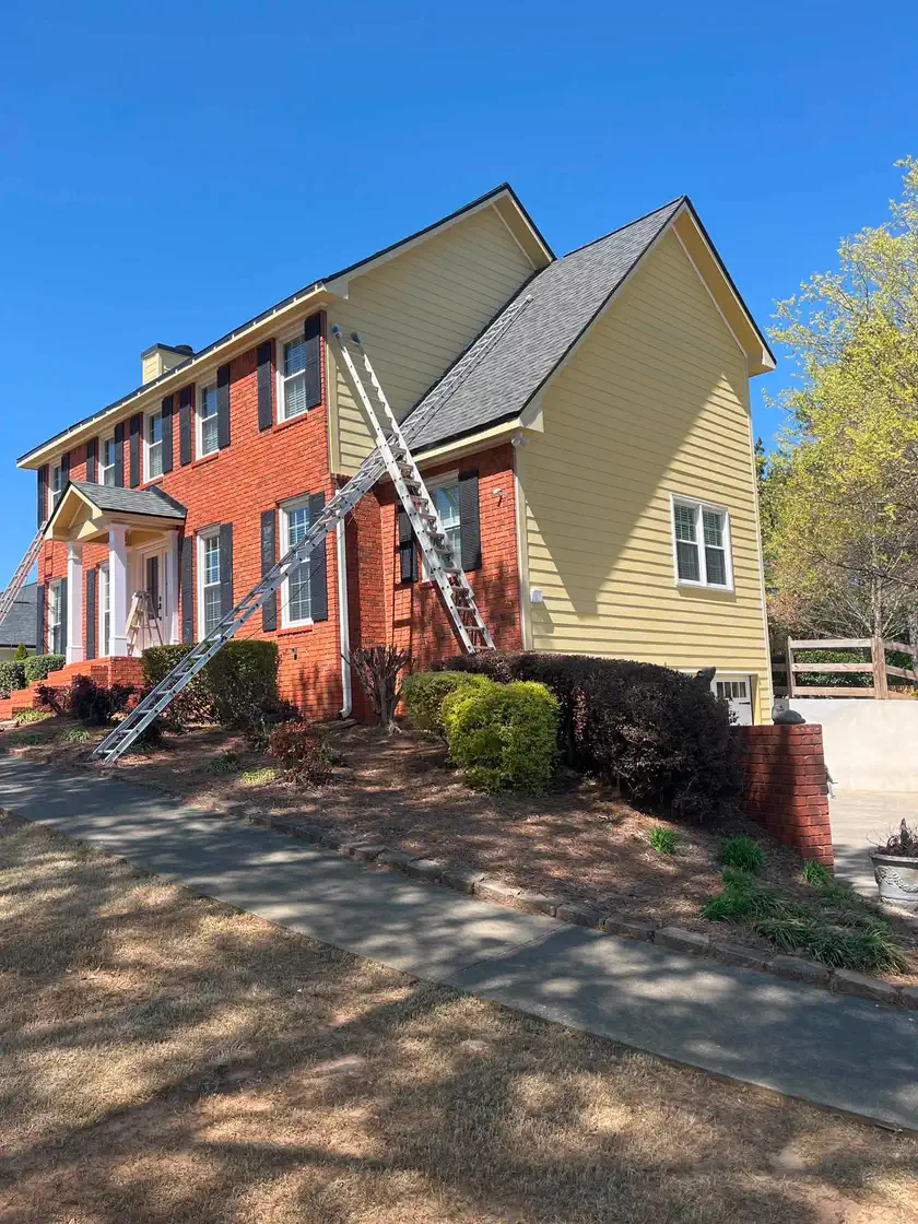 Wide front view of the yellow and red brick exterior before repainting
