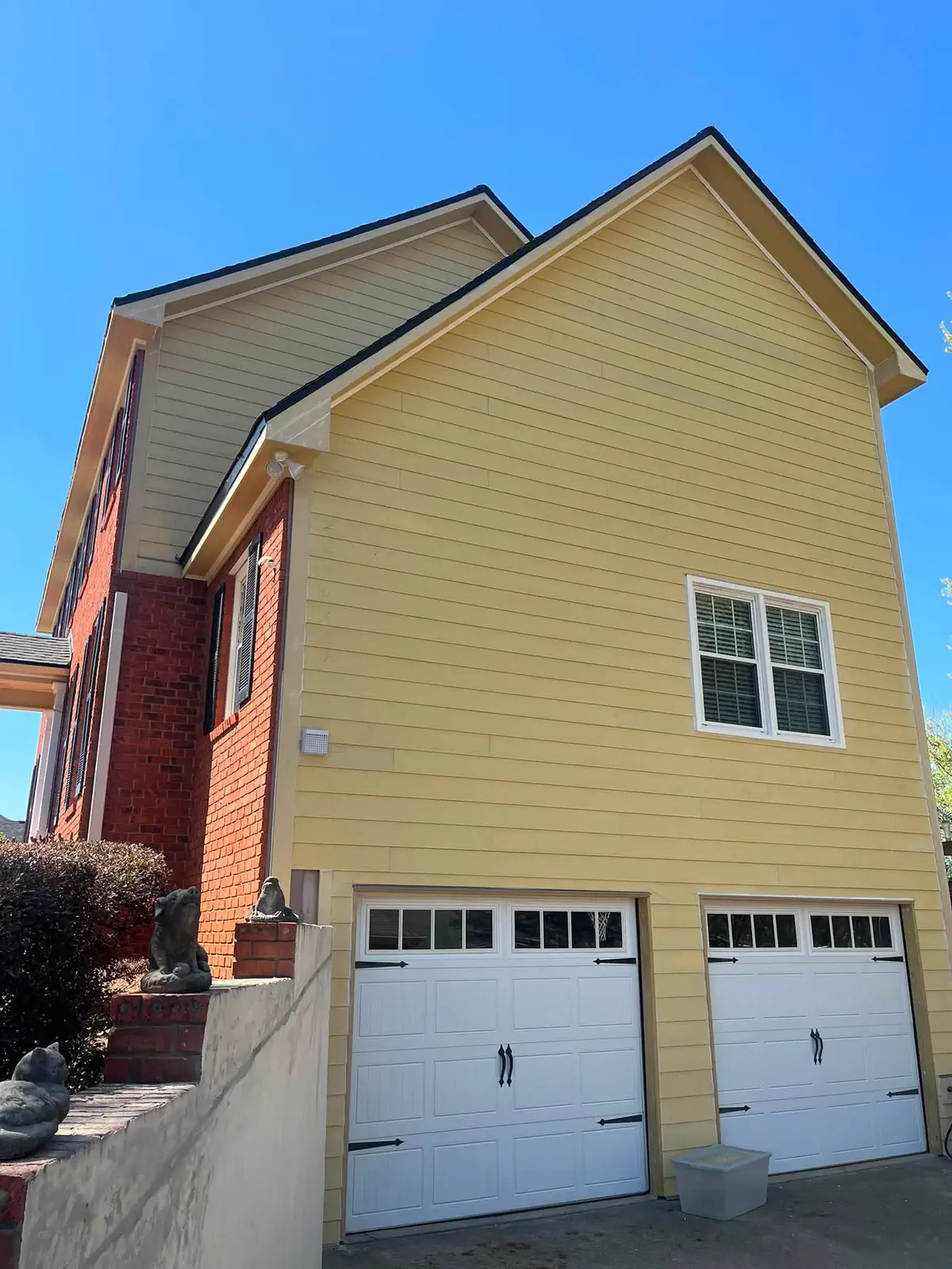 Yellow garage elevation before the exterior repainting work