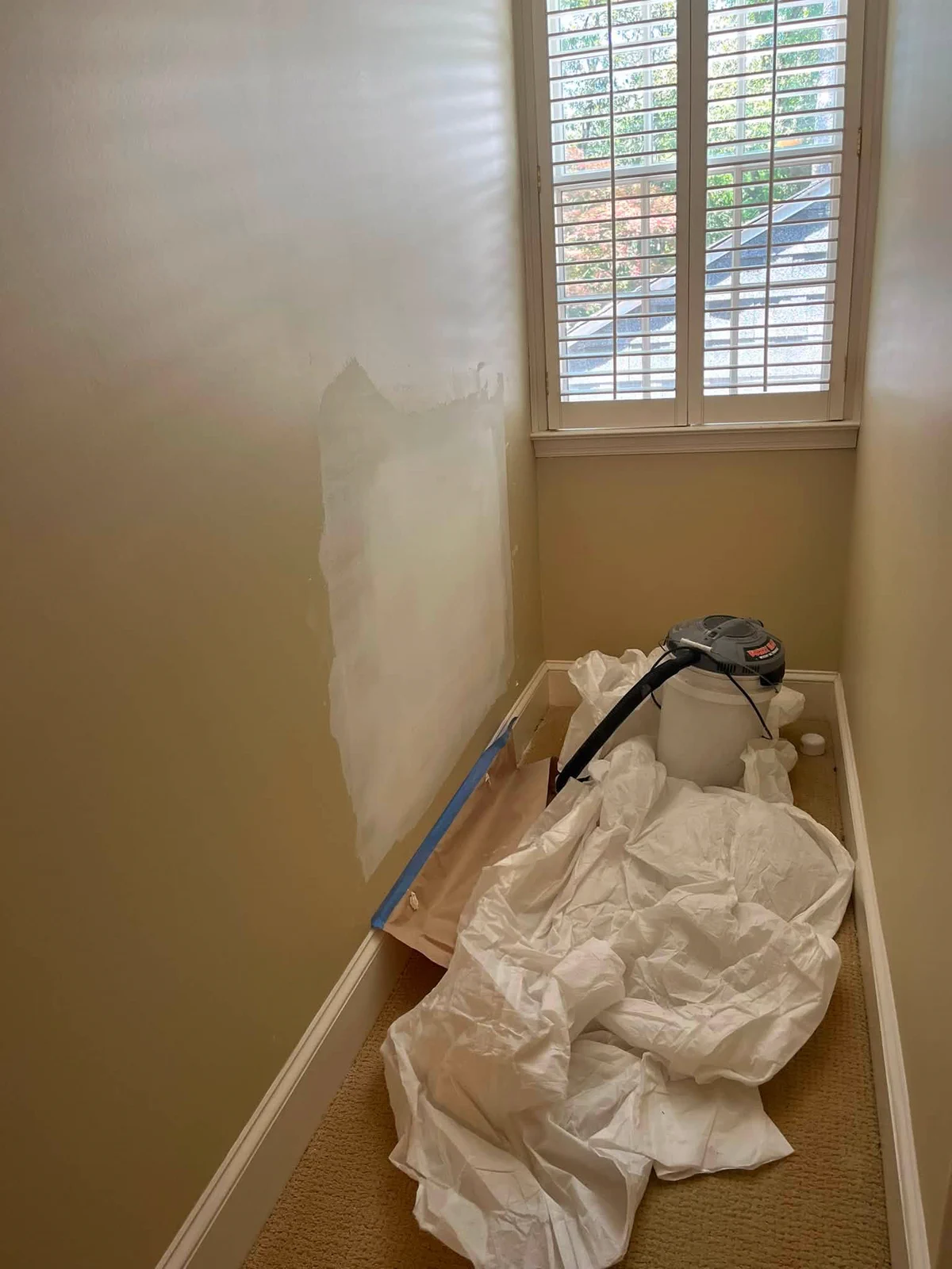 Stairwell walls protected and prepared for interior painting