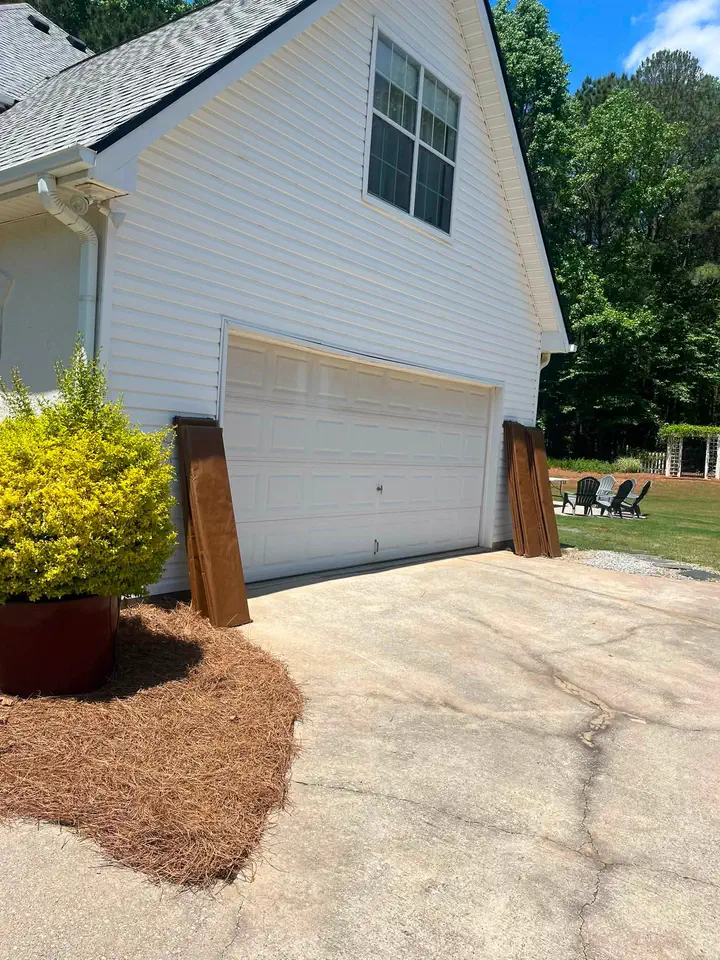 Fresh white exterior finish around the garage side of the home