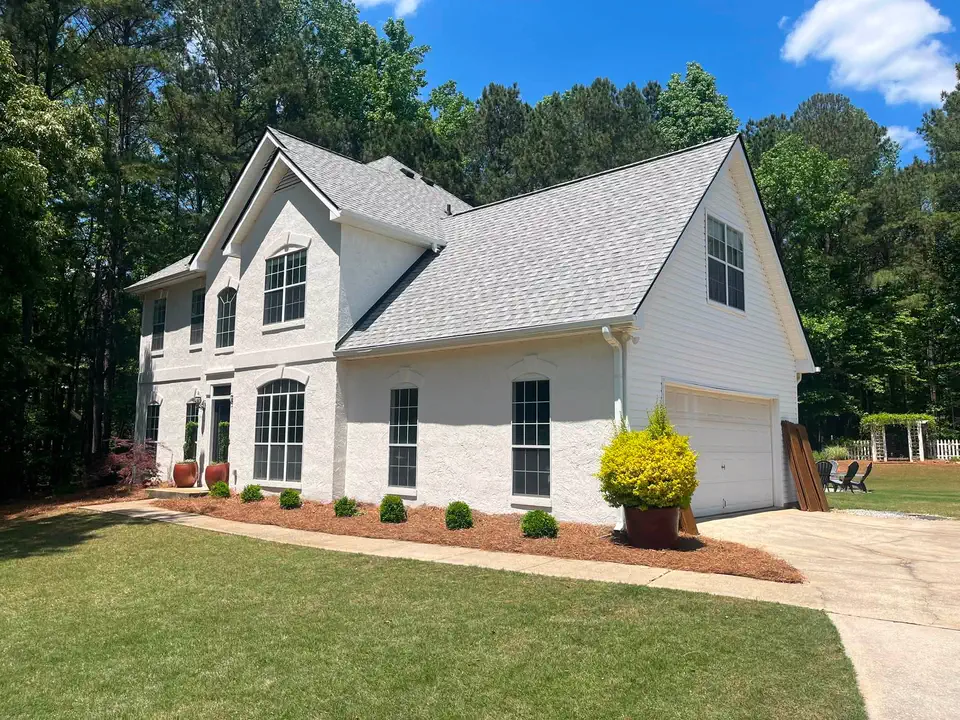 Completed white brick exterior viewed from the side yard